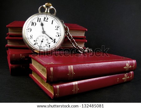 Antique pocket watch and books concept