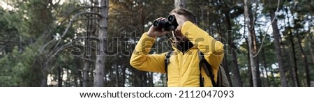 Similar – Image, Stock Photo Traveling man looking in binoculars in winter forest