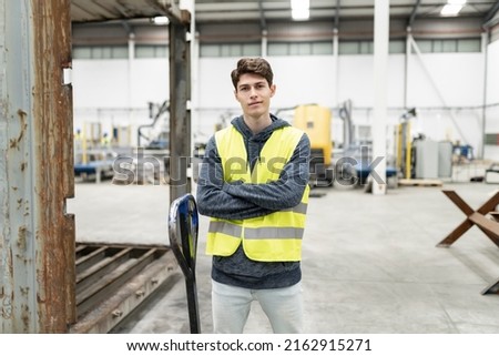 Similar – Image, Stock Photo Male warehouse employee in uniform standing near rack in warehouse