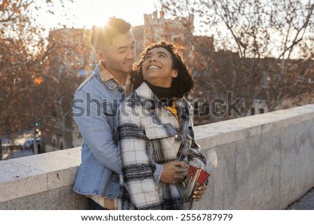 Similar – Image, Stock Photo Couple embracing on bridge under arch with flowers