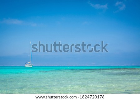 white sand,blue water,boat,beach ,Chrissi island.Greece
