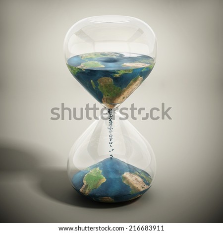 Melting world concept with earth textured sand pouring inside the hourglass.  Image includes elements furnished by NASA.