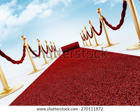 Rolled red carpet and velvet ropes against the blue sky