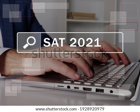  SAT 2021 Scholastic Assessment Test text in search bar. Broker looking for something at laptop. SAT 2021 Scholastic Assessment Test concept.  Stok fotoğraf © 