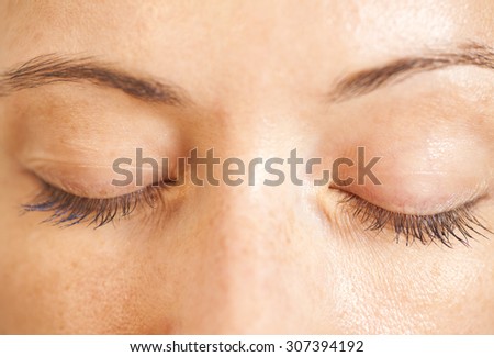 Closeup shot of woman closed eyes with makeup