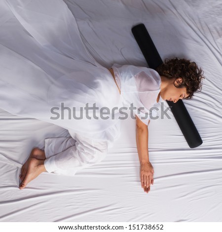 Woman in fetal position on white background