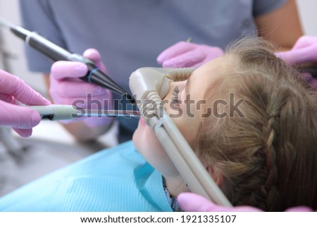 Dental care for children. Superficial sedation. Treatment of children's teeth with nitrous oxide. Photos in the interior of the clinic. Side view. Stock foto © 