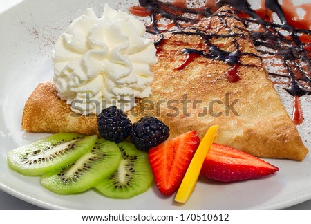 pancake with fruit, berries and cream with topping