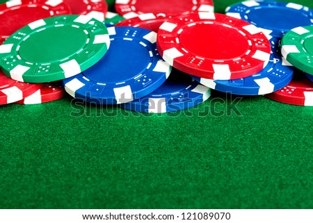 Group of poker chips on the green cloth.