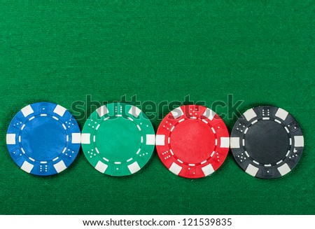Group of poker chips on the green cloth.
