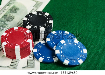 Group of chips and money on the green cloth.
