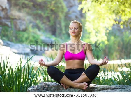 Yoga. Young woman doing yoga asana in beautiful nature outdoor