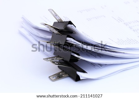 bunch of paperwork with black paper clippers isolated for business organization study neat and tidy