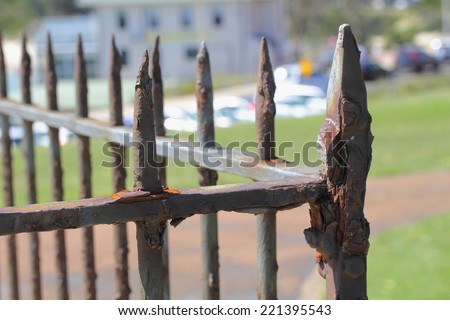 old rusty sharp metal strong fence texture close up in the sun outdoor