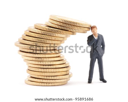 Figure of businessman and stack of coins