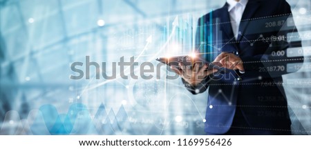 Photo of Businessman using tablet analyzing sales data and economic growth graph chart.  Business strategy. Abstract icon. Digital marketing.