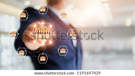 Businessman hand touching icon global network connection on franchise marketing system. Branch of market and customer. Modern technology business. Сток-фото © 