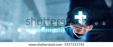 Businessman hold virtual medical network connection icons. Covid-19 pandemic develop people awareness and spread attention on their healthcare, rising growth in hospital and health insurance business.