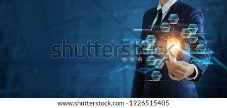 Businessman hand holding creative light bulb with marketing network icons on planning strategy, analysis solution and development, Modern business, Innovative of new ideas. 