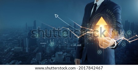 Business development to success and growth of banking and financial on global network. Businessman hold pointing arrow up and graph corporate future growth plan on network structure of business. 