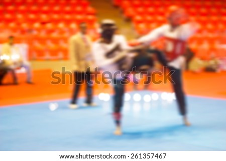 colorful martial arts fighting in indoor stadium, soft and blur concept