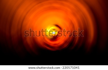 Abstract background of spin circle radial motion blur in orange and black tone