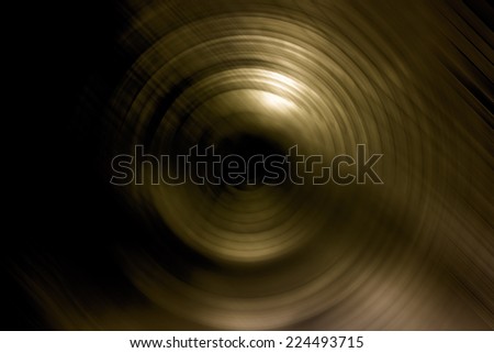 Abstract background of spin circle radial motion blur in metallic gold effect