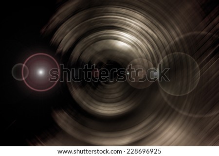 Abstract background of spin circle radial motion blur in metallic gold with flare