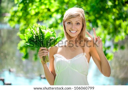 Young beautiful artistic woman with flowers outdoors