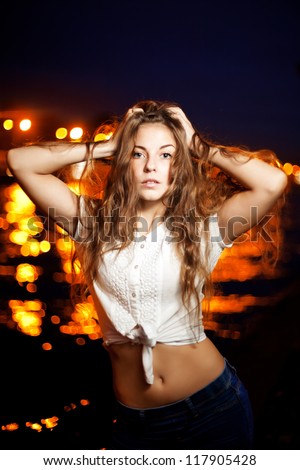 Beautiful woman on the background of night city lights
