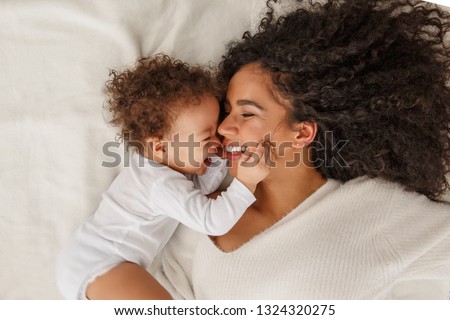 Similar – Image, Stock Photo Mother and young child at beach playing with water