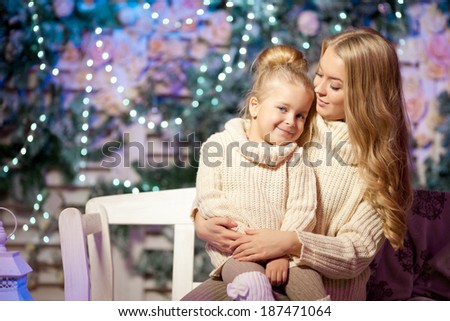 Winter mother and daughter. Smiling beauty woman and child. Cute girl with kid.