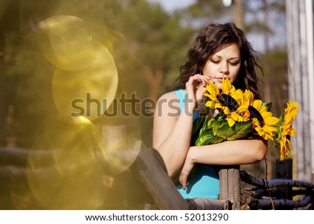 The image of the girl in the countryside with sunflowers