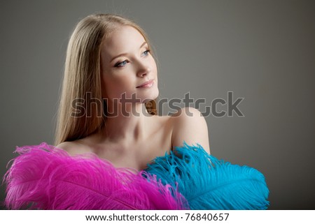 The image of a beautiful girl with colorful feathers