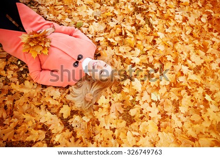Autumn woman on background fall landscape leaves of trees. Model on autumn season. Fashion people.