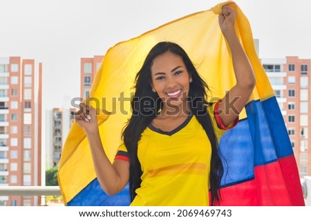 Cheerful woman with Colombian flag. Colombian soccer, Colombia national team, goal shout. Photo stock © 