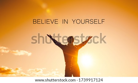 Believe in yourself concept. silhouette of a man with arms raised to the sky Foto d'archivio © 