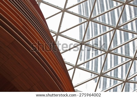 Fragment of contemporary hi-tech building with transparent roof. Tilt view of contemporary architecture with entire glazing in a concept of transparency, innovation or cutting-edge business