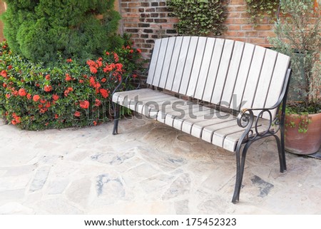 Bench in the park is a leisure area. An ornamental shrub on the side. Give it a rest people