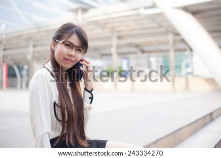 Businesswoman talking phone. Happy while talking on the phone.