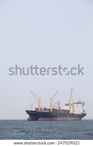 Large cargo ship Boats moored in the sea to make sense compared to the coast.