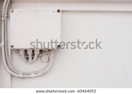 the electronic box on the wall, white color electronic box on the wall