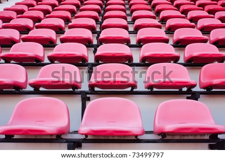 Red chairs on the miraculous. To watch a sporting event in the field.