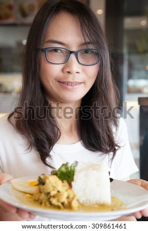 asia woman hold thai food.woman wear eyeglasses. relax and smile wear eyeglasses.