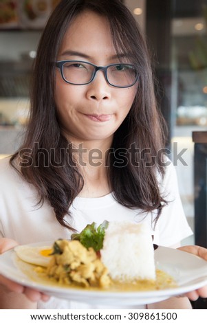 asia woman hold thai food.woman wear eyeglasses. relax and smile wear eyeglasses.