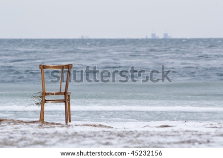 Chair washed ashore from the sea onto Amager Strand. BarsebÃ¤ck nuclear power plant in Sweden is seen in the background.