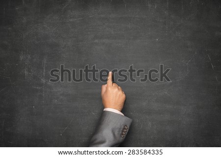 Blank black blackboard with businessman hand pointing