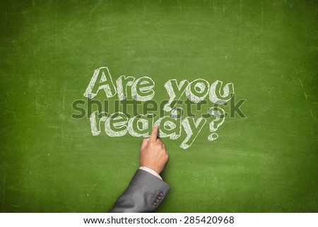 Are you ready concept on green blackboard with businessman hand holding paper plane