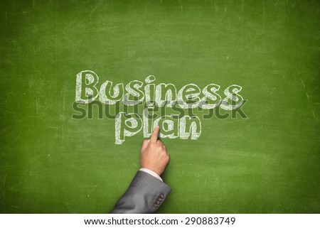 Business plan concept on green blackboard with businessman hand holding paper plane