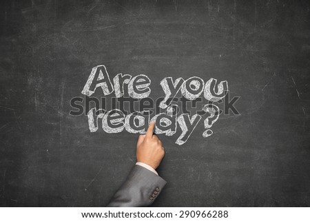 Are you ready concept on black blackboard with businessman hand pointing